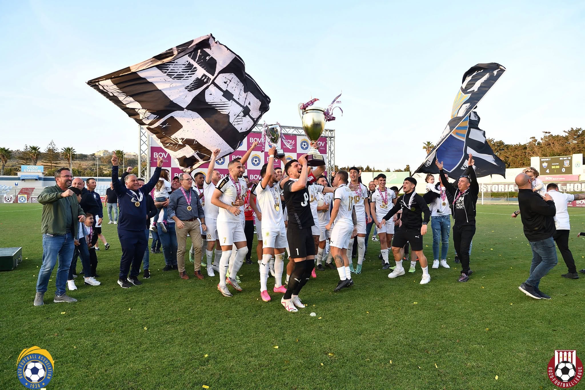 Nadur Youngsters players and supporters celebrating with trophies at the Gozo Stadium